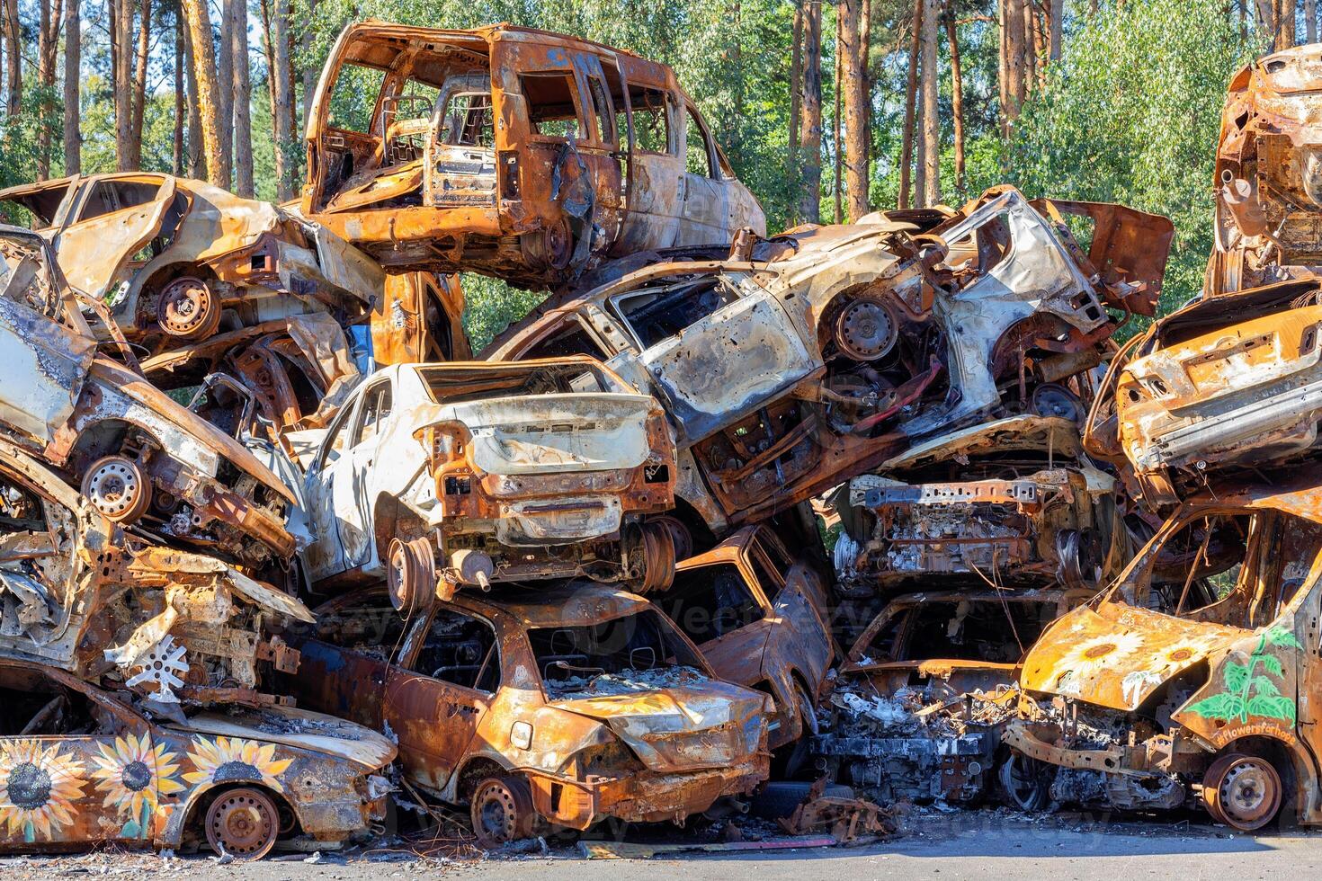 Cemetery of wrecked and destroyed civilian vehicles near Kiev during the fighting during the Russian invasion of Ukraine. photo