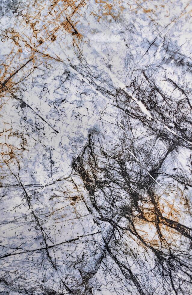 An abstract pattern on white with blue marble, streaked with black cracks and veins. photo