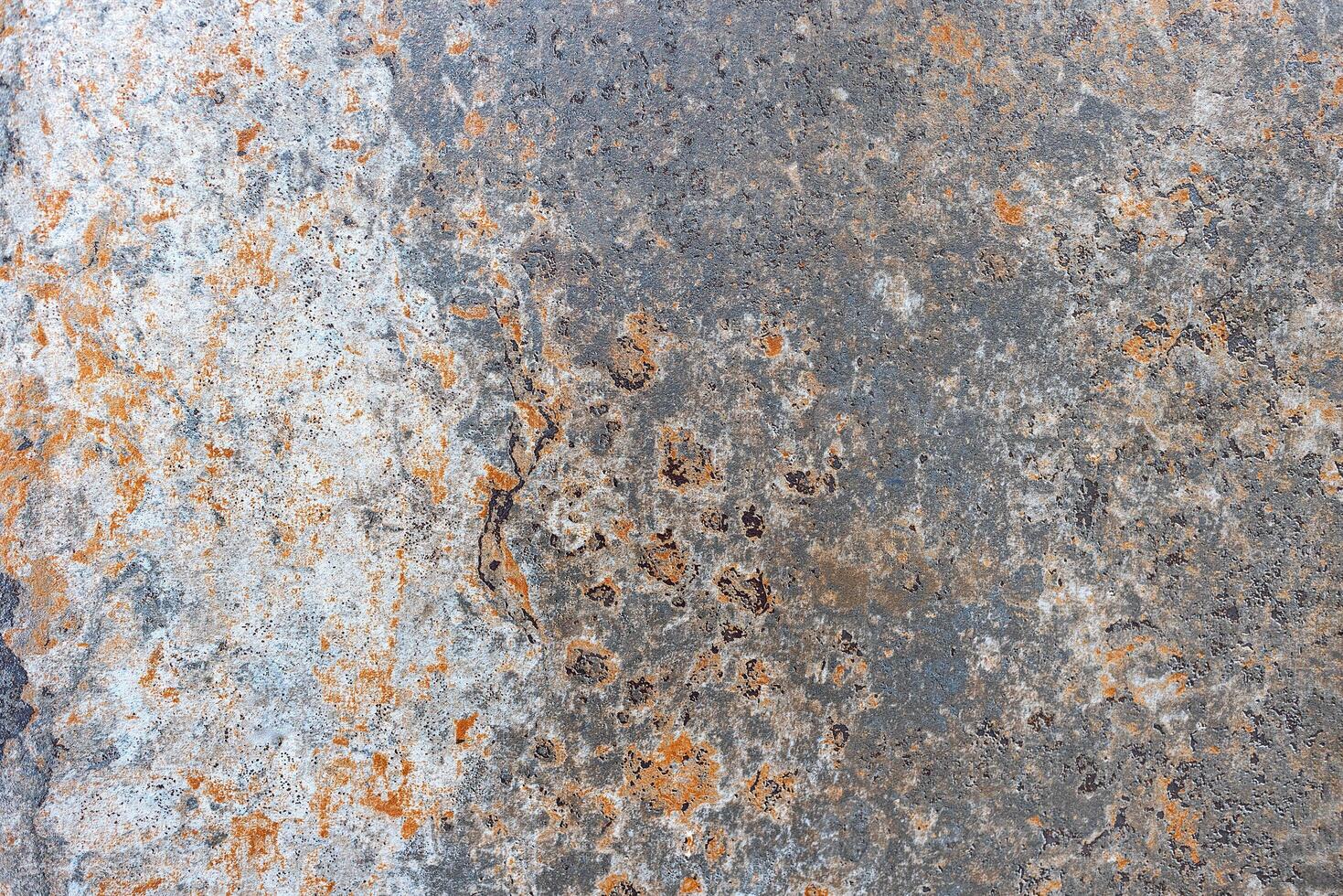 Showing traces of rust over old paint on the surface of a metal sheet. photo