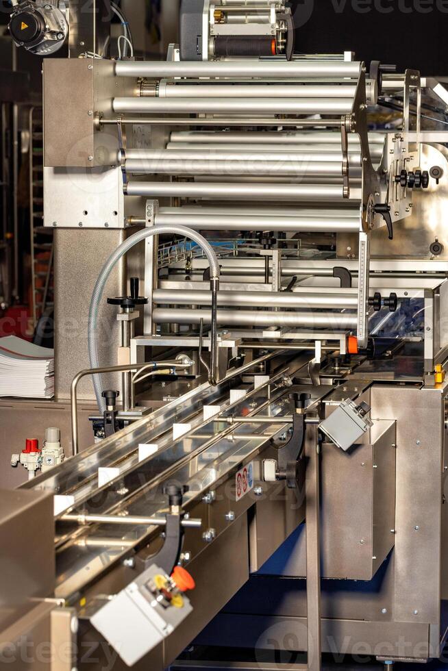 Automatic packaging conveyor line, vertical image. photo