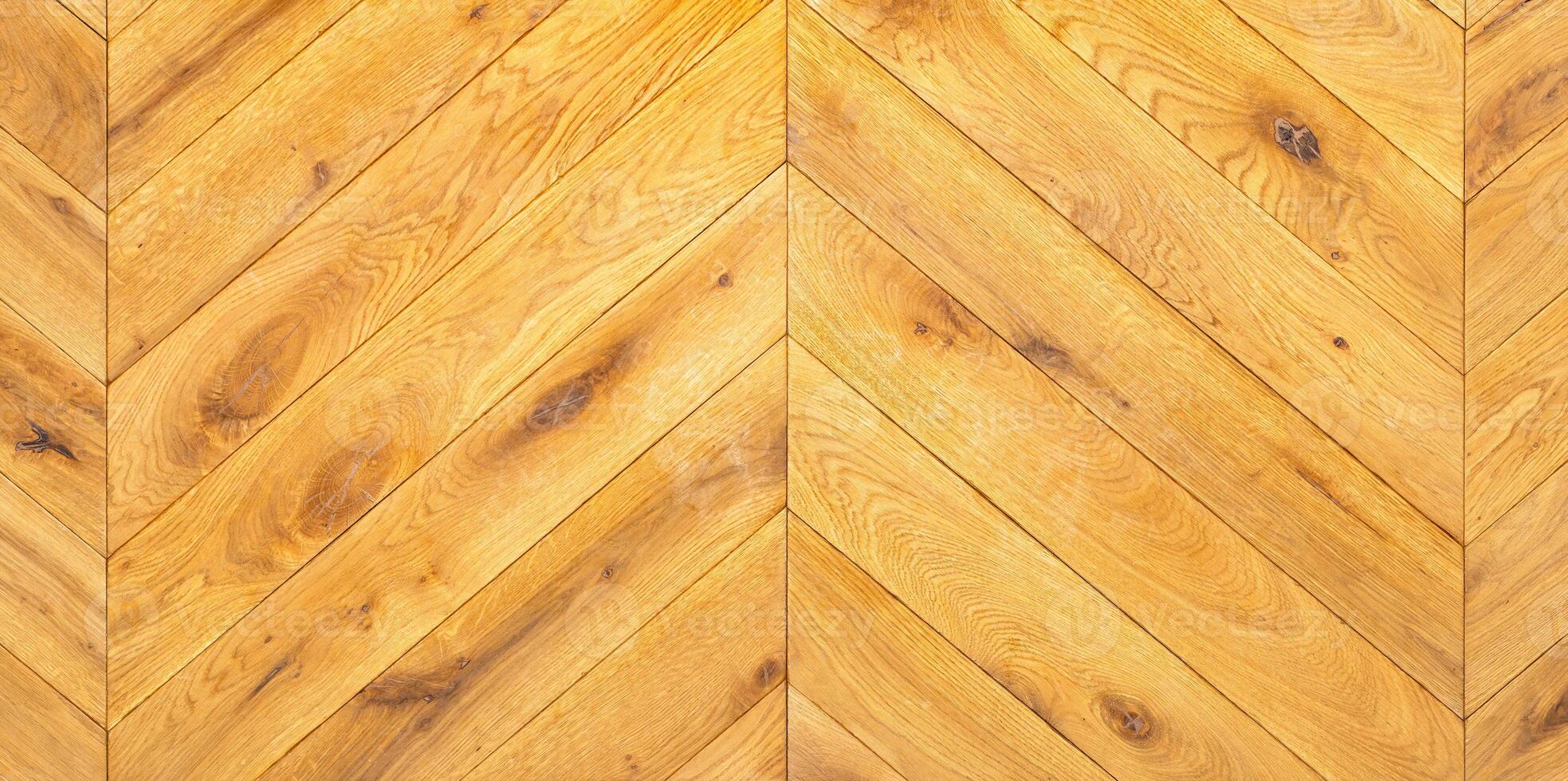 Tightly laid wooden parquet in a herringbone shape with a clear grain pattern. photo