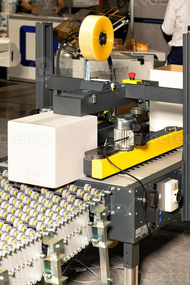 Automatic line for packaging various products on a conveyor. photo