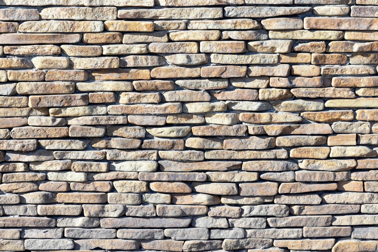 The texture of a stone wall made from large river pebbles. photo