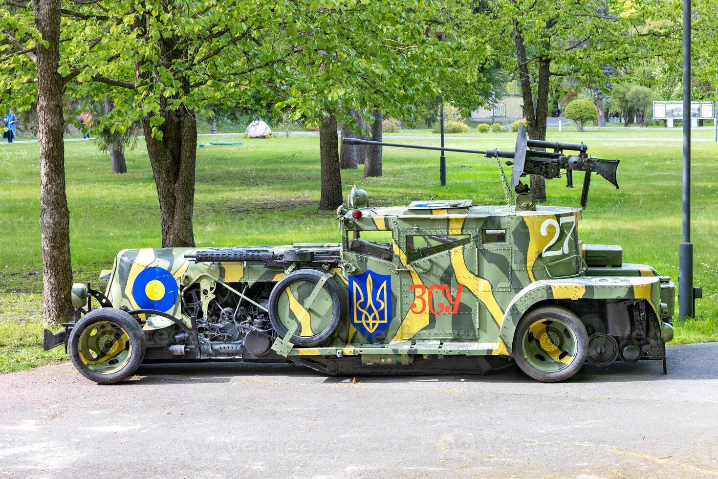 The armored car is stylized as an antique car, painted in camouflage colors with the coat of arms of Ukraine. 05.09.2023. Kyiv, Ukraine. photo