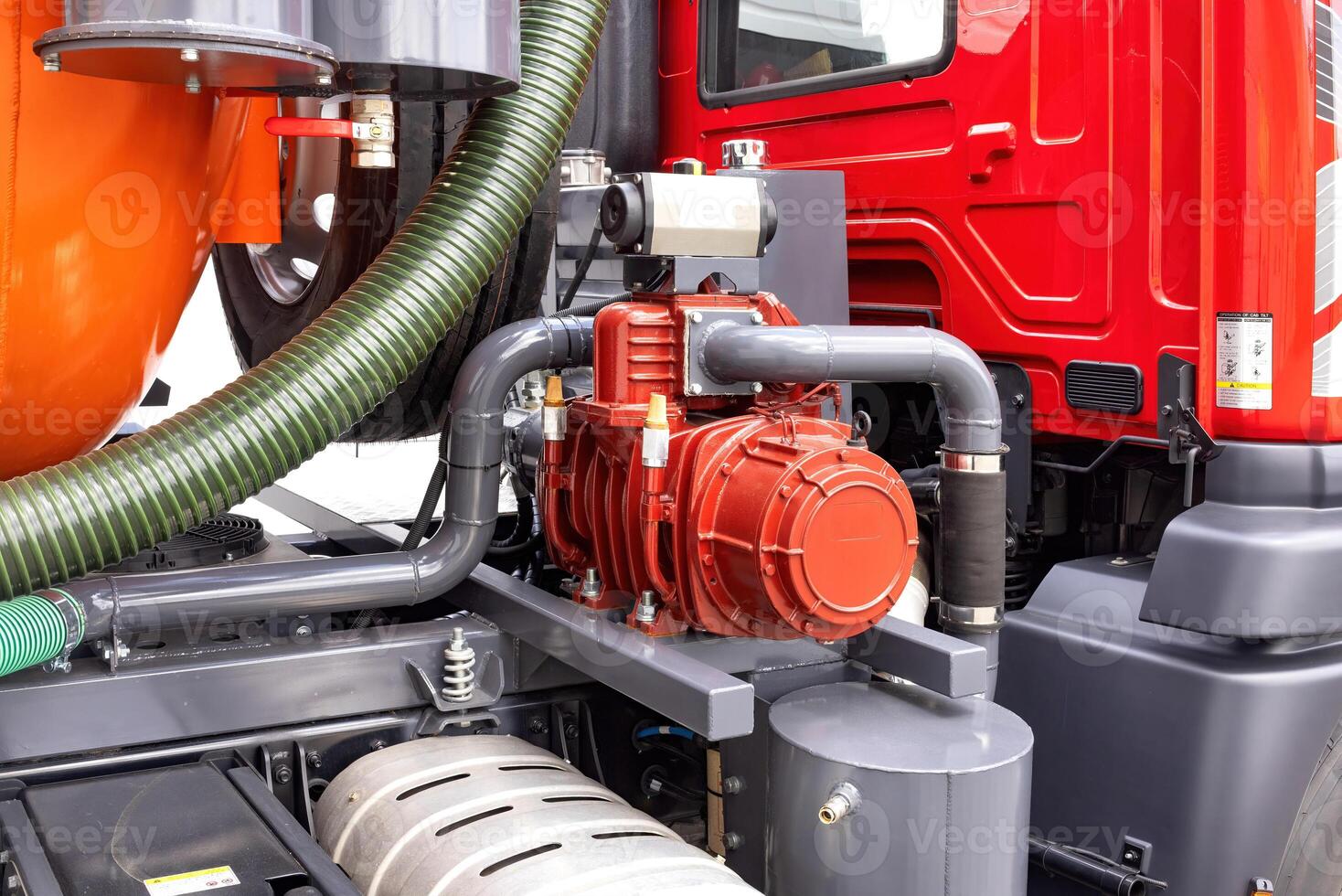 Industrial machinery with vibrant red equipment, focus on hydraulic pump details, representing mechanical engineering concept photo