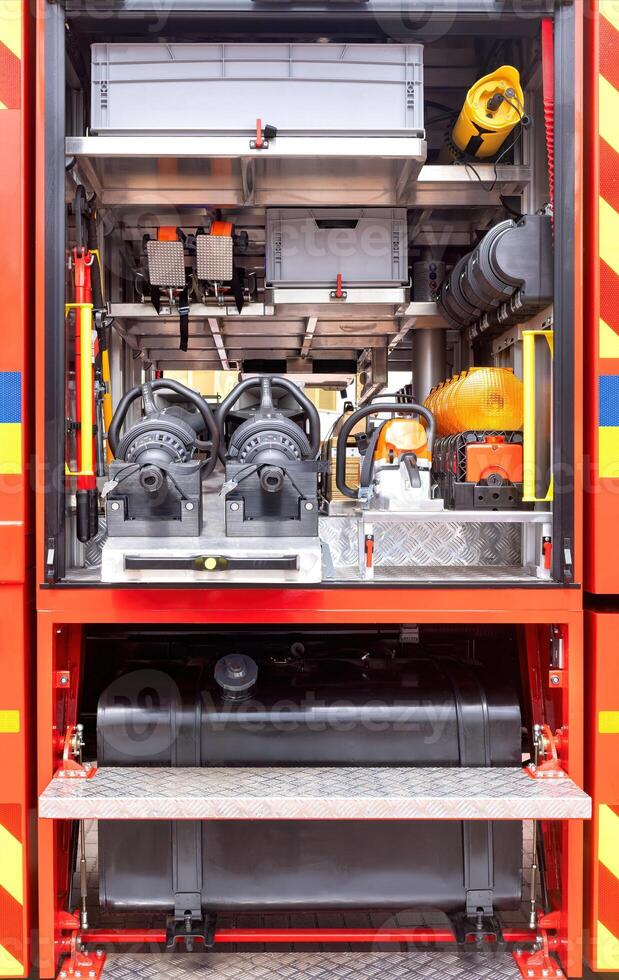 Detailed view, organized firefighting equipment in fire truck storage compartments, essential rescue gear, emergency response tools image, firefighting concept photo