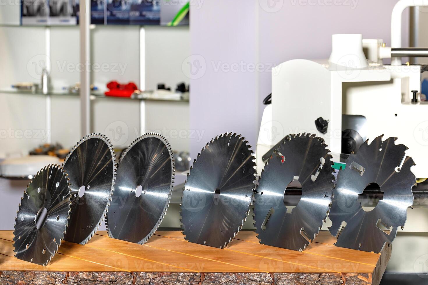 Various circular saw blades displayed on a wooden table in a workshop setting for tools enthusiasts photo