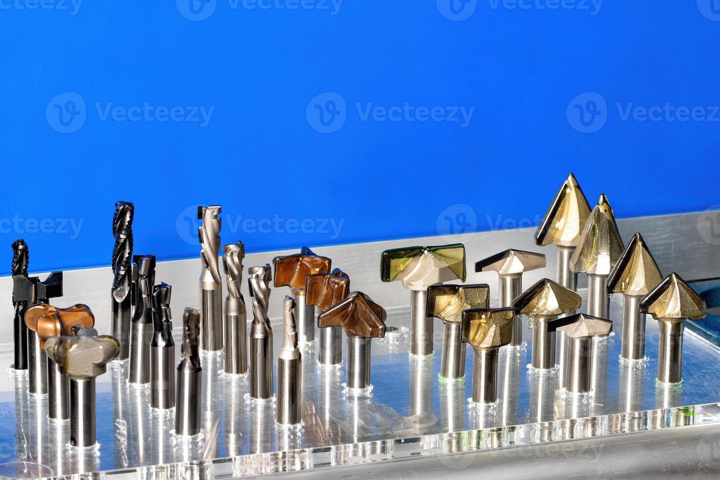 A vibrant display of cutting tools arranged beautifully against a striking blue backdrop. Copy space. photo