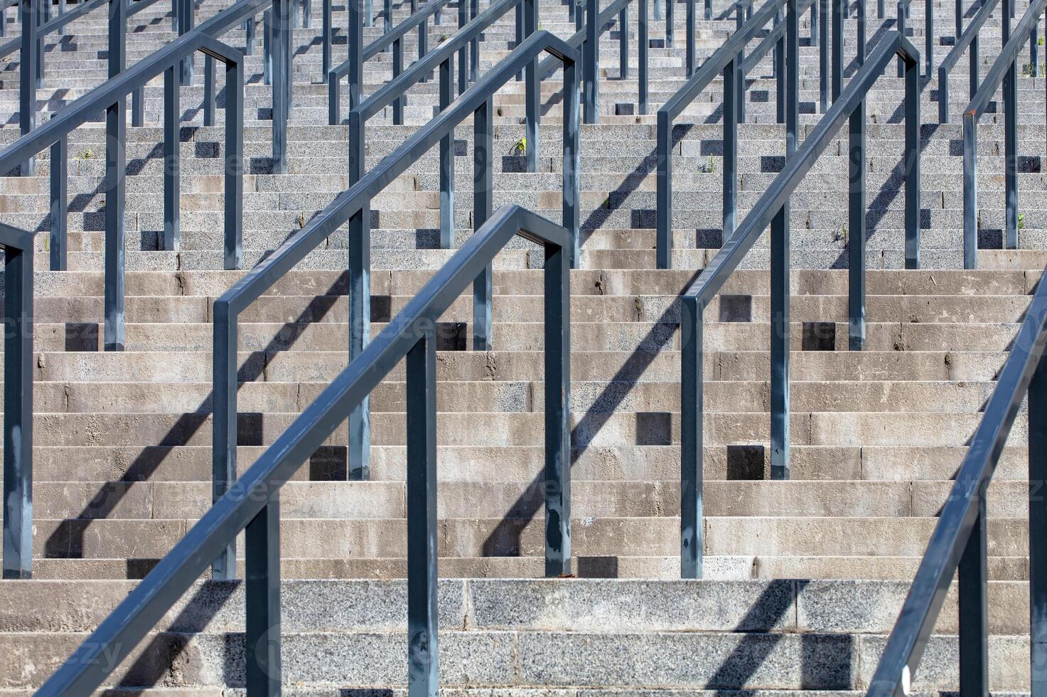 Steps leading upward gracefully in bright sunlight amidst urban architecture photo