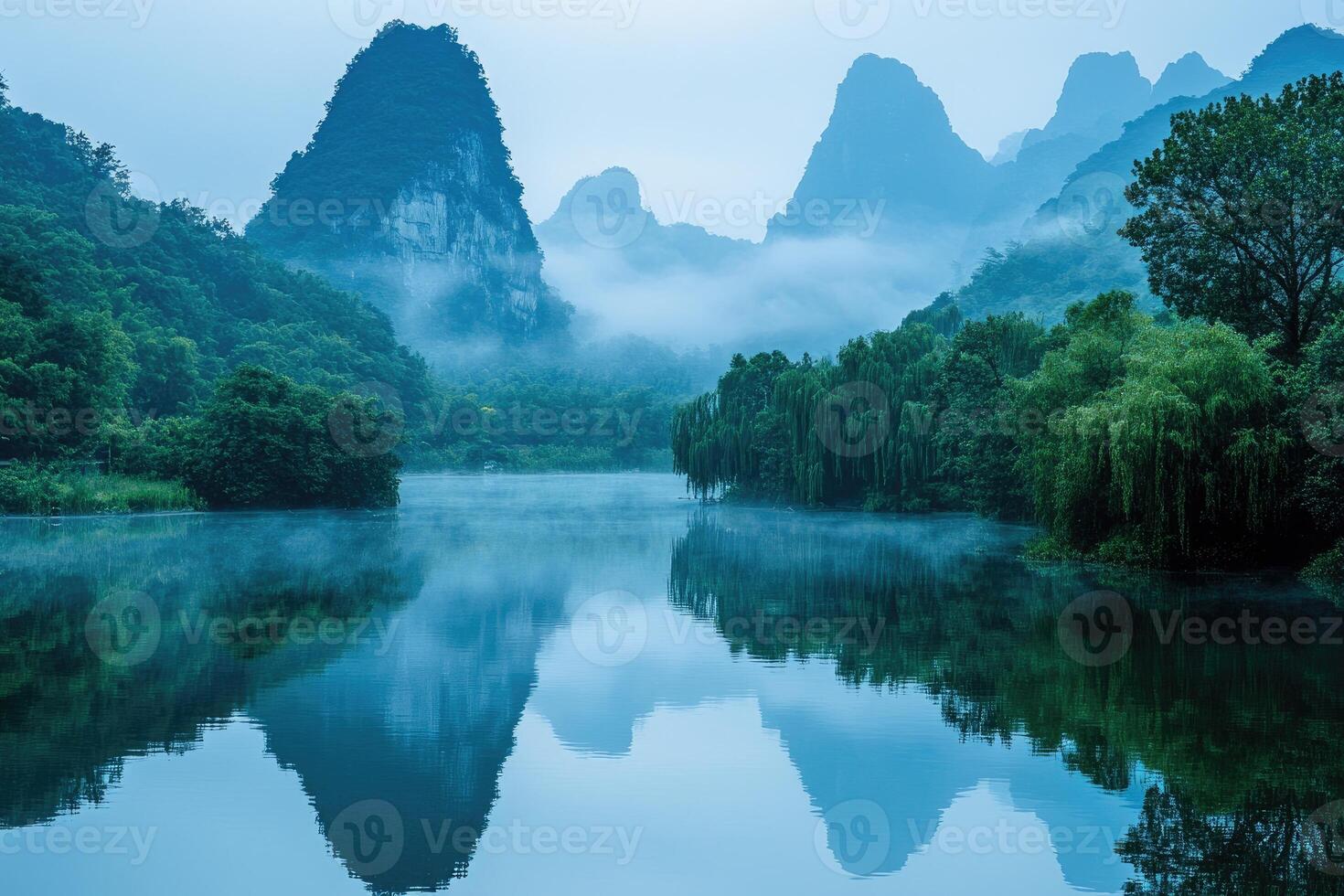 Misty morning on the li river reflecting karst mountains in guilin, china photo