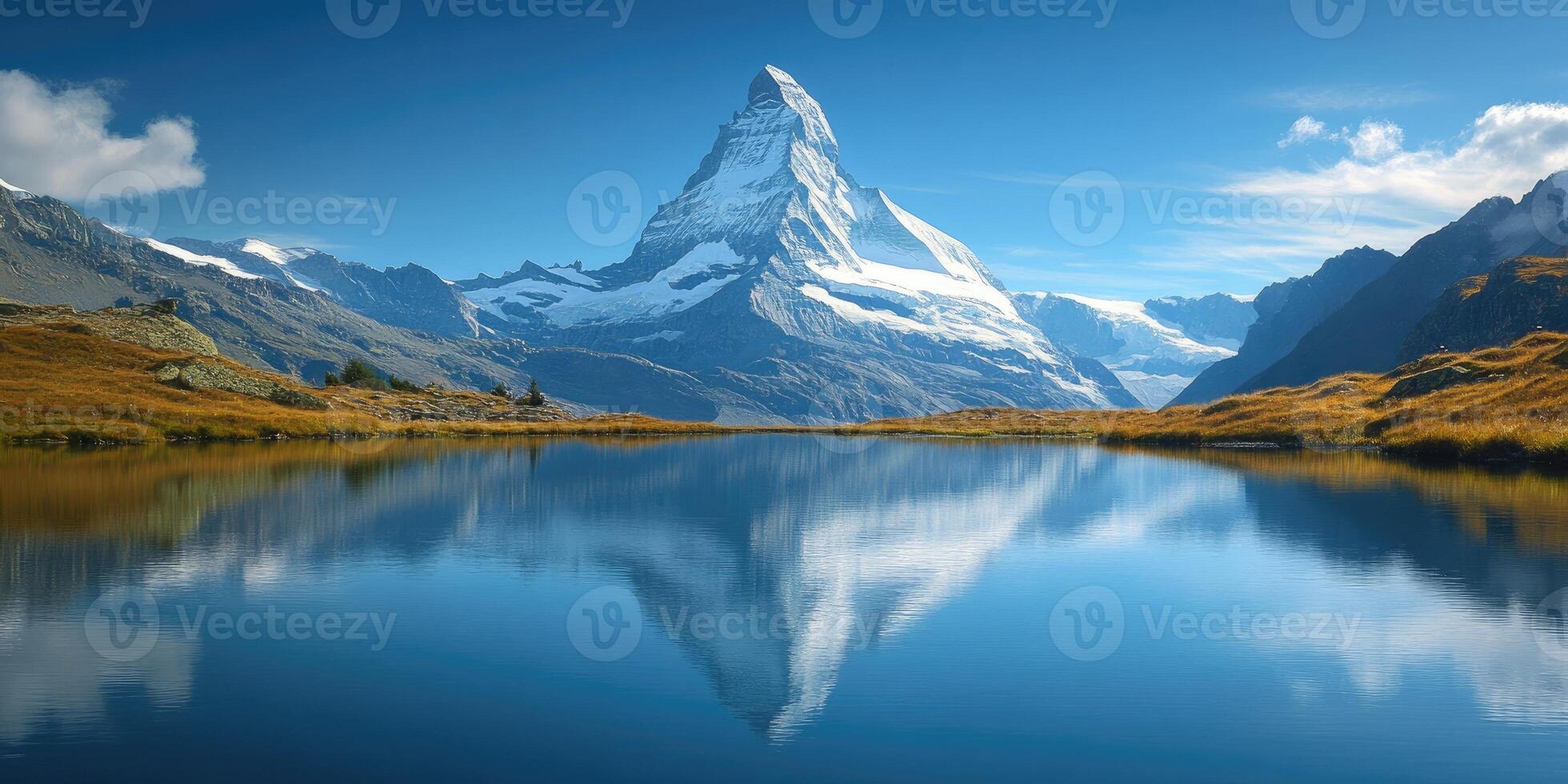 Matterhorn reflecting in stellisee lake on a sunny day with clouds and blue sky photo