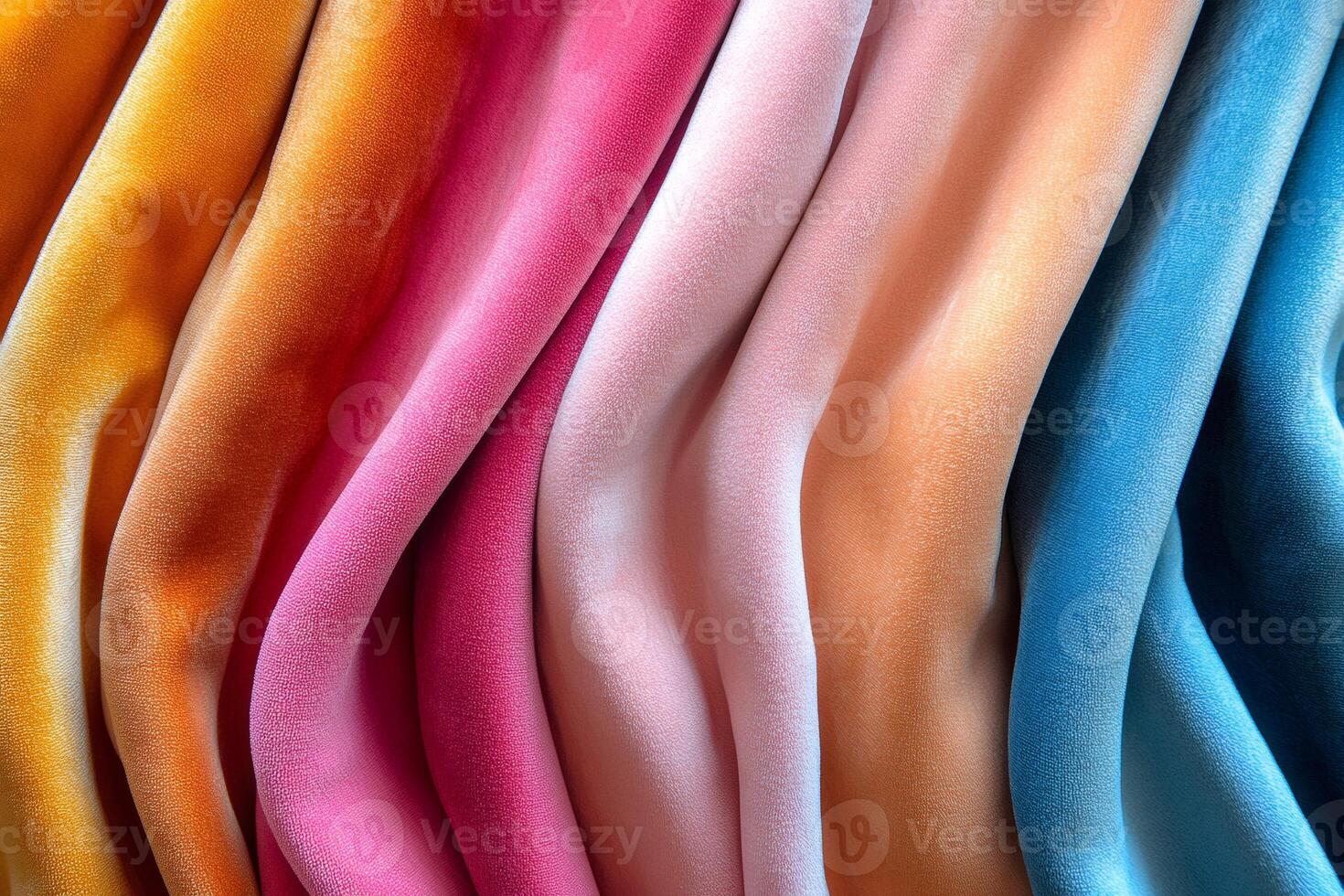 Colorful velvet fabric draped in gentle waves creating a soft textured background photo