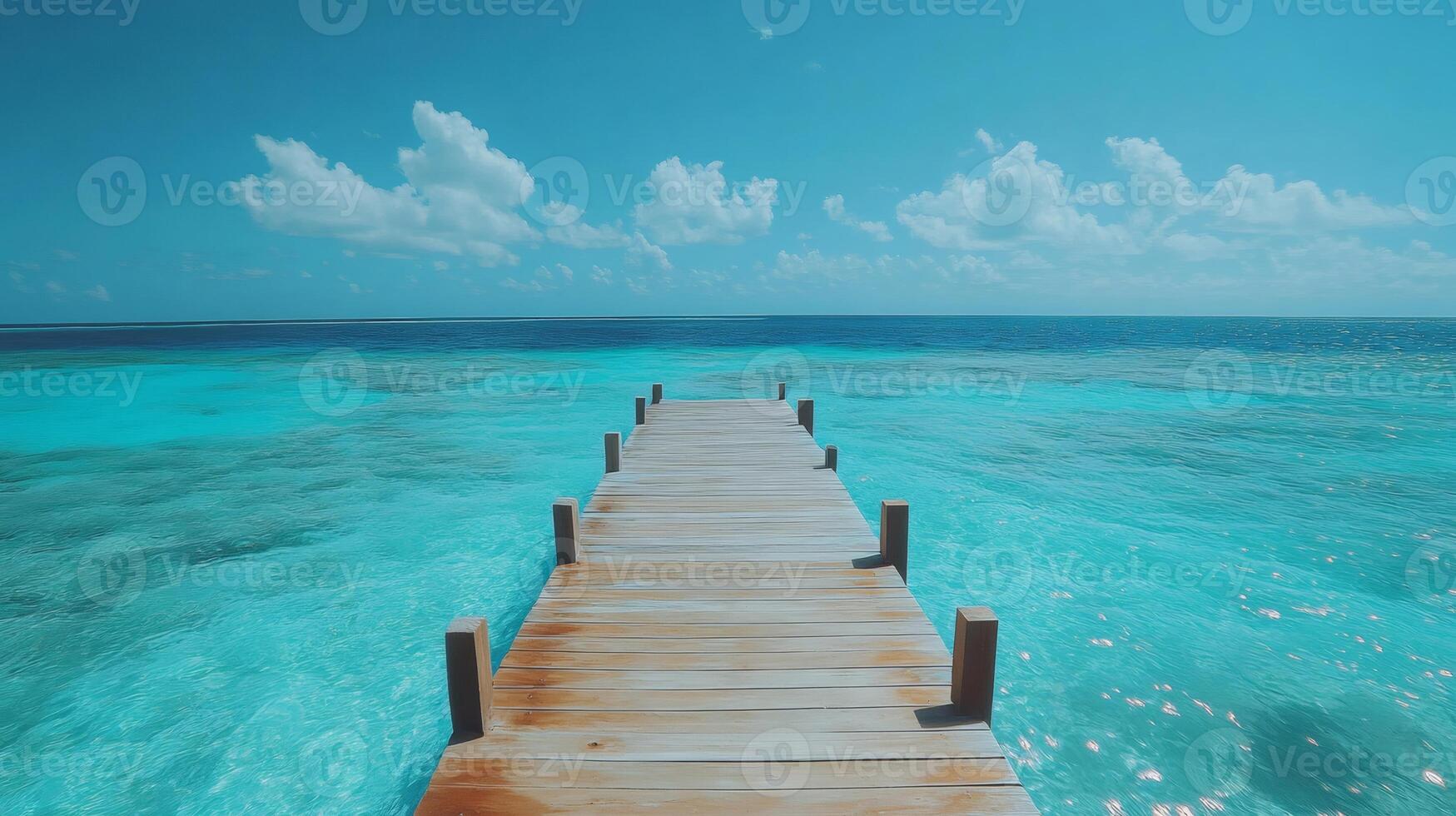 Wooden pier stretching into the turquoise ocean paradise under a cloudy sky photo