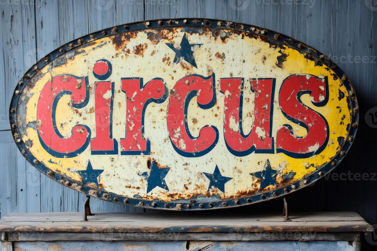 Old weathered circus sign displaying red lettering and stars on yellow background photo