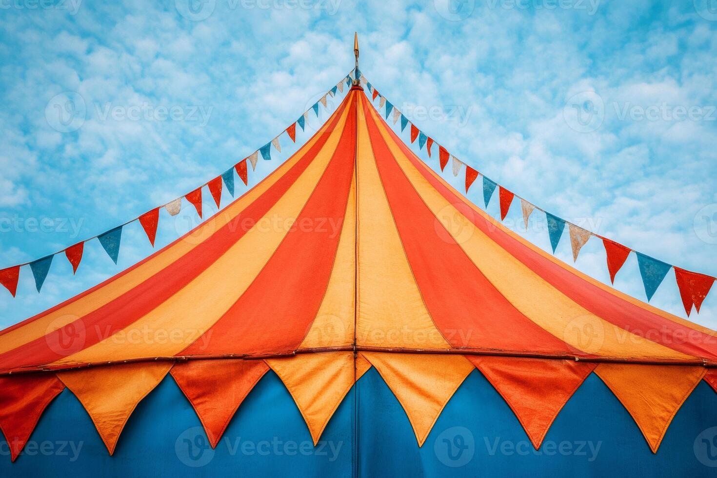 Colorful circus tent top with flags waving in the wind photo