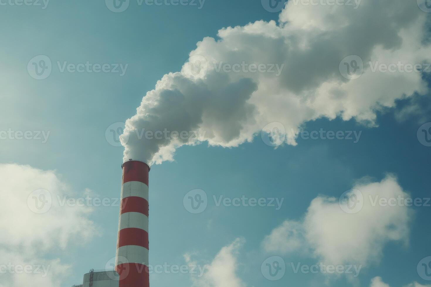 Industrial chimney emitting smoke into the atmosphere photo