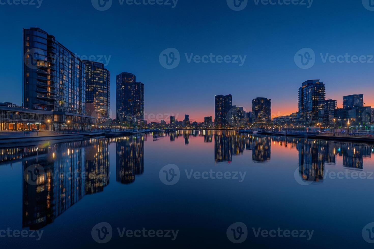 Melbourne docklands reflecting in water at dusk with colorful sky photo