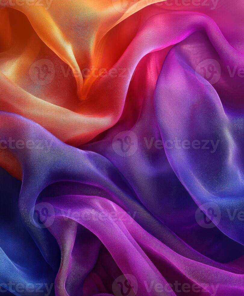 Colorful silk fabric draping elegantly with beautiful gradient patterns photo