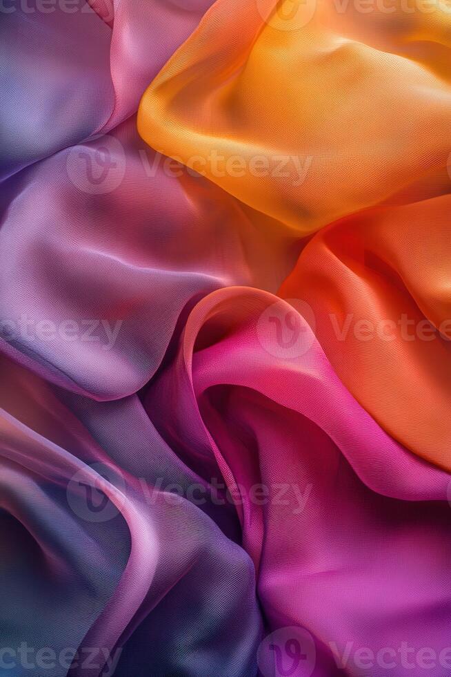 Colorful fabric drapes in soft folds creating a vibrant texture display photo
