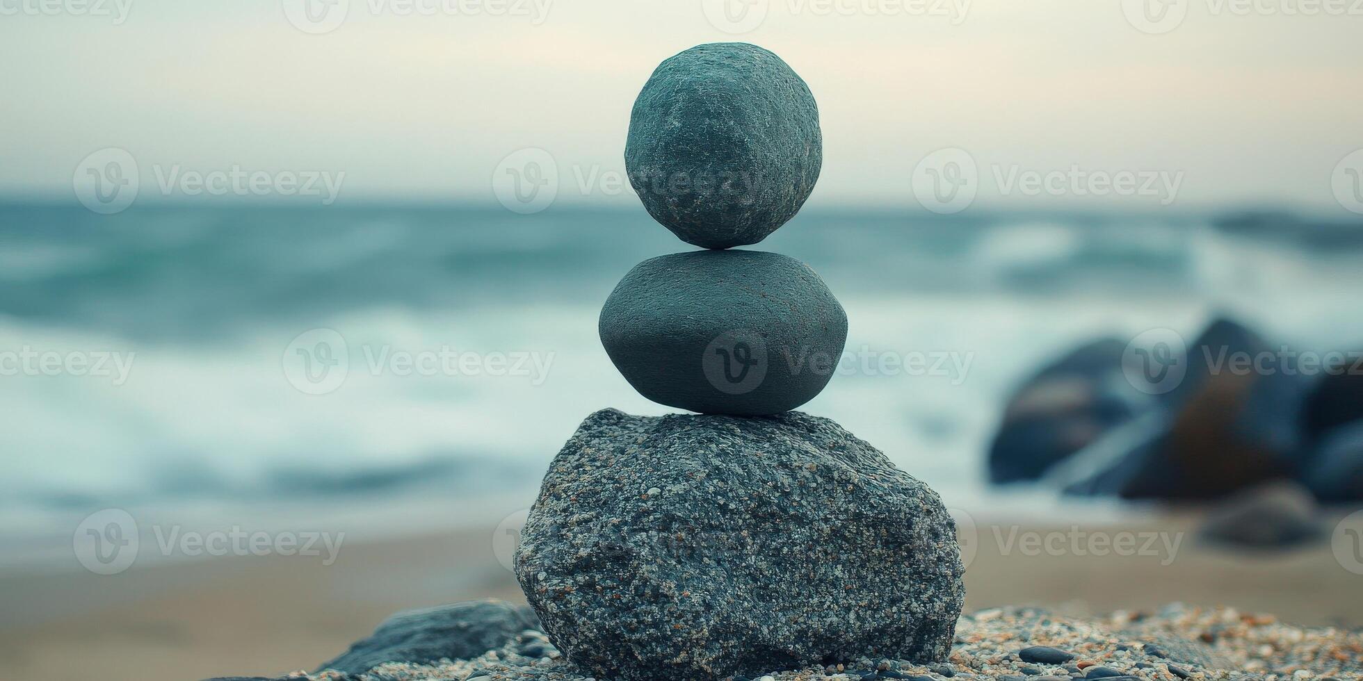 Balanced stones on the beach during sunset create a serene atmosphere photo