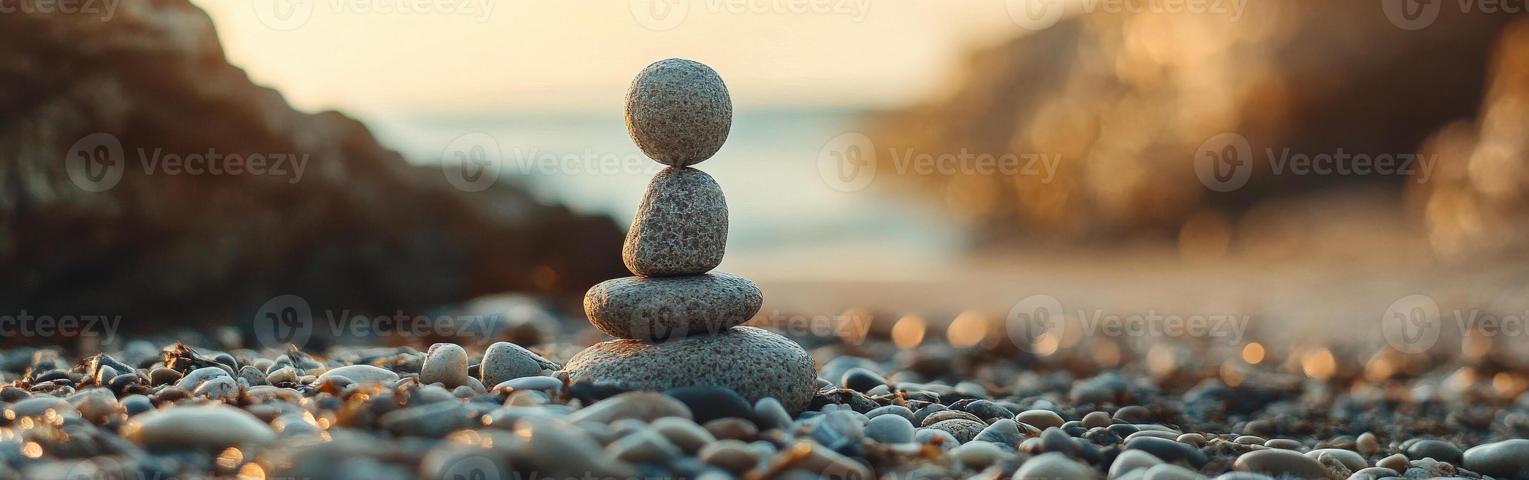 Stacked stones on a beach at sunset creating a peaceful atmosphere photo