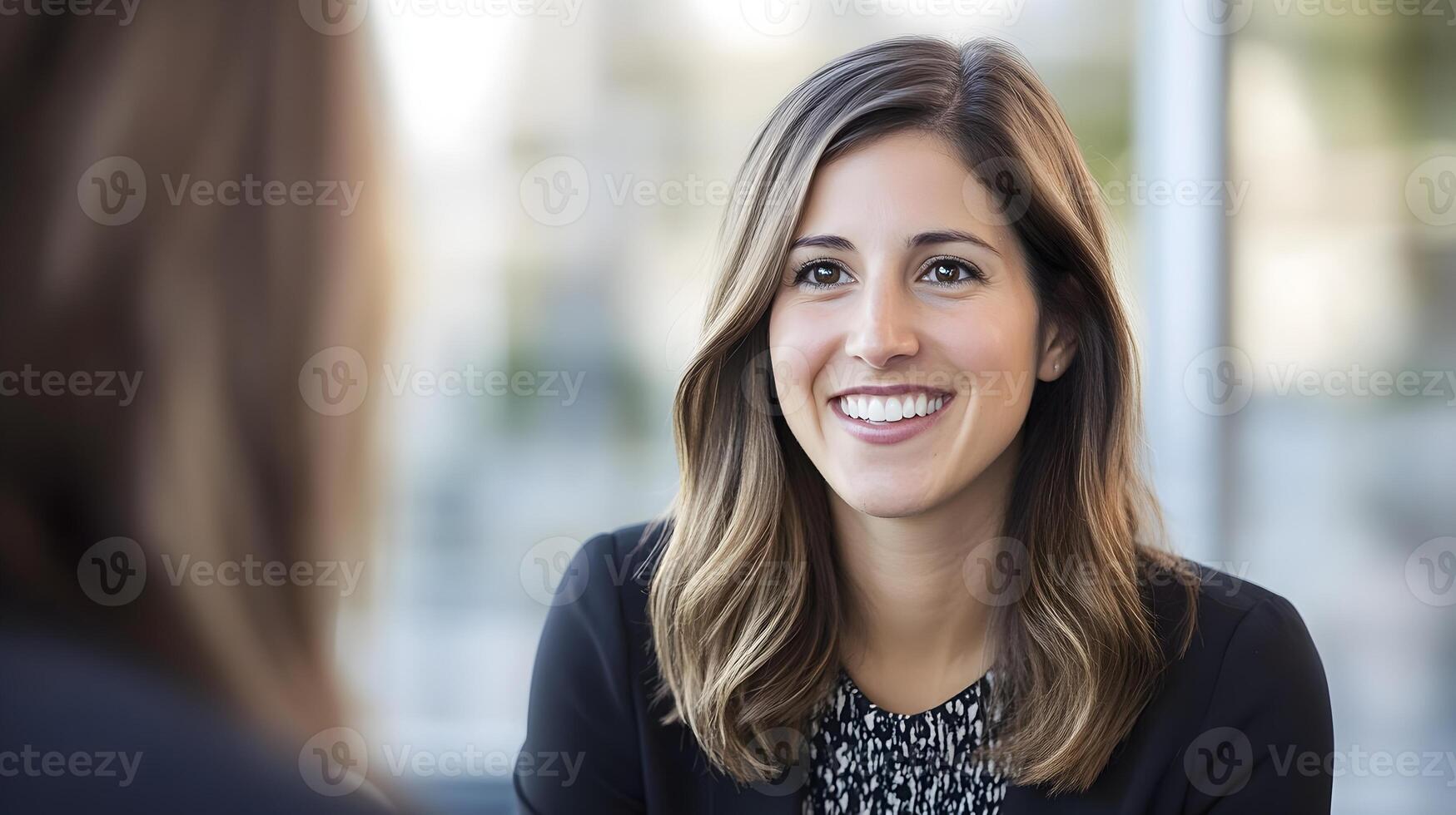 HR manager conducting a one-on-one interview with a smiling candidate in a modern office environment photo