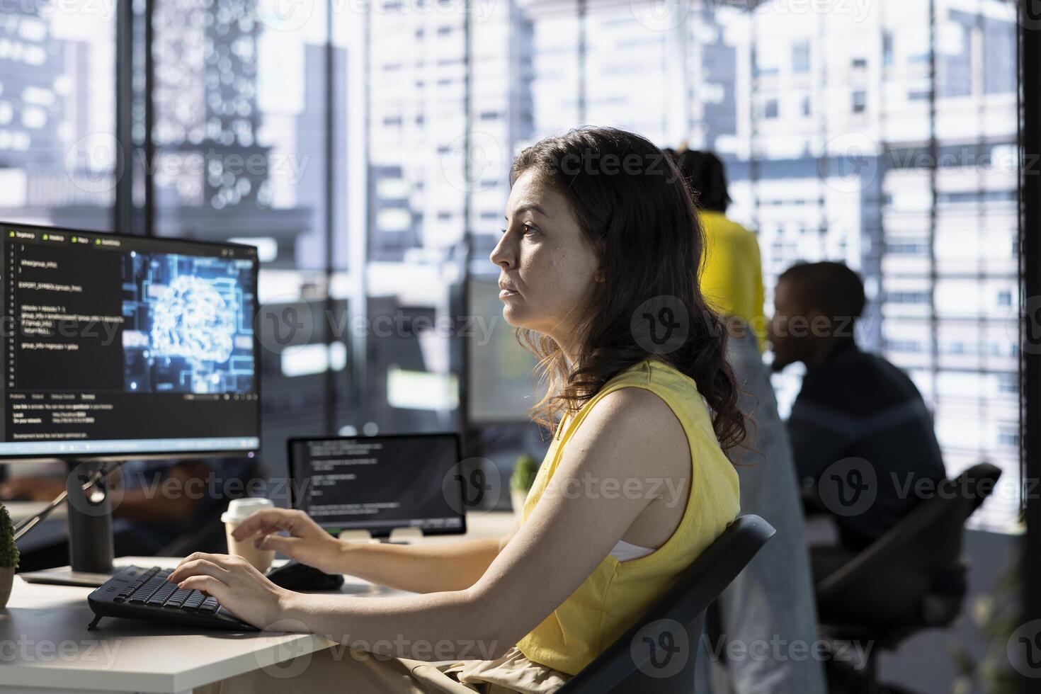 Data scientist utilizing cloud computing resources and platforms to train and deploy large scale machine learning models. Woman in business office monitoring and maintaining company systems photo
