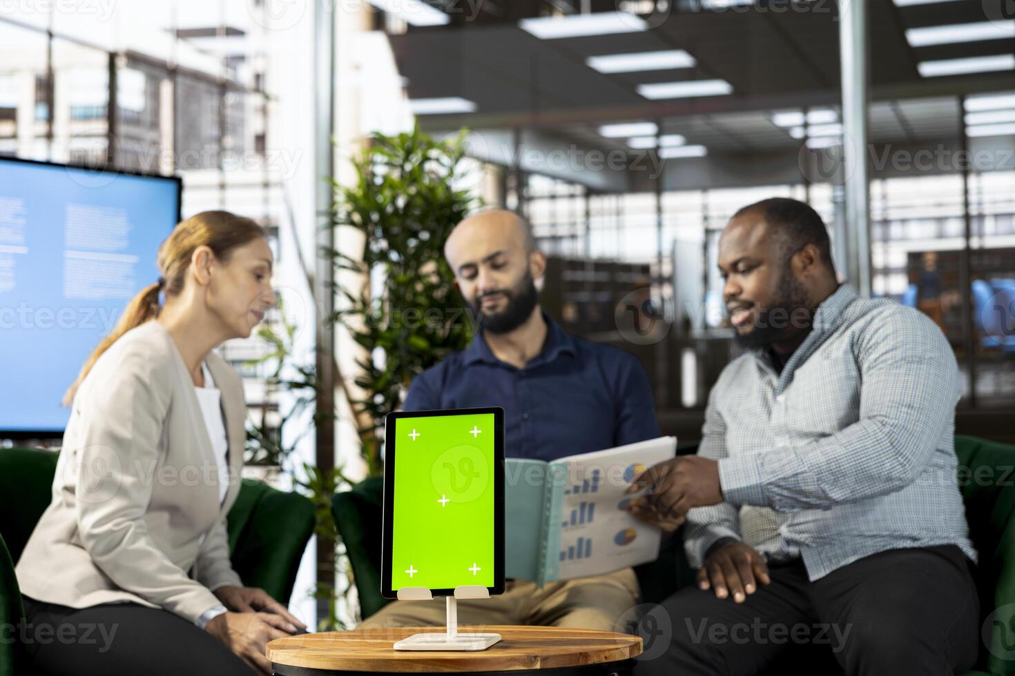 Startup CEO attends meeting to talk about new business vision with executive board member, using isolated screen tablet. Men using mockup device to pitch investment strategy to manager photo