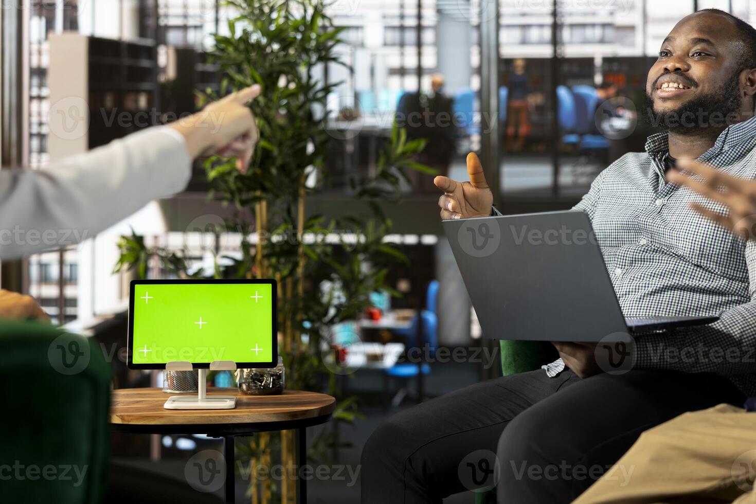 Isolated screen tablet next to smiling employee chatting with coworker during business meeting. Mockup device next to jolly worker having fun with colleague while doing research analysis photo