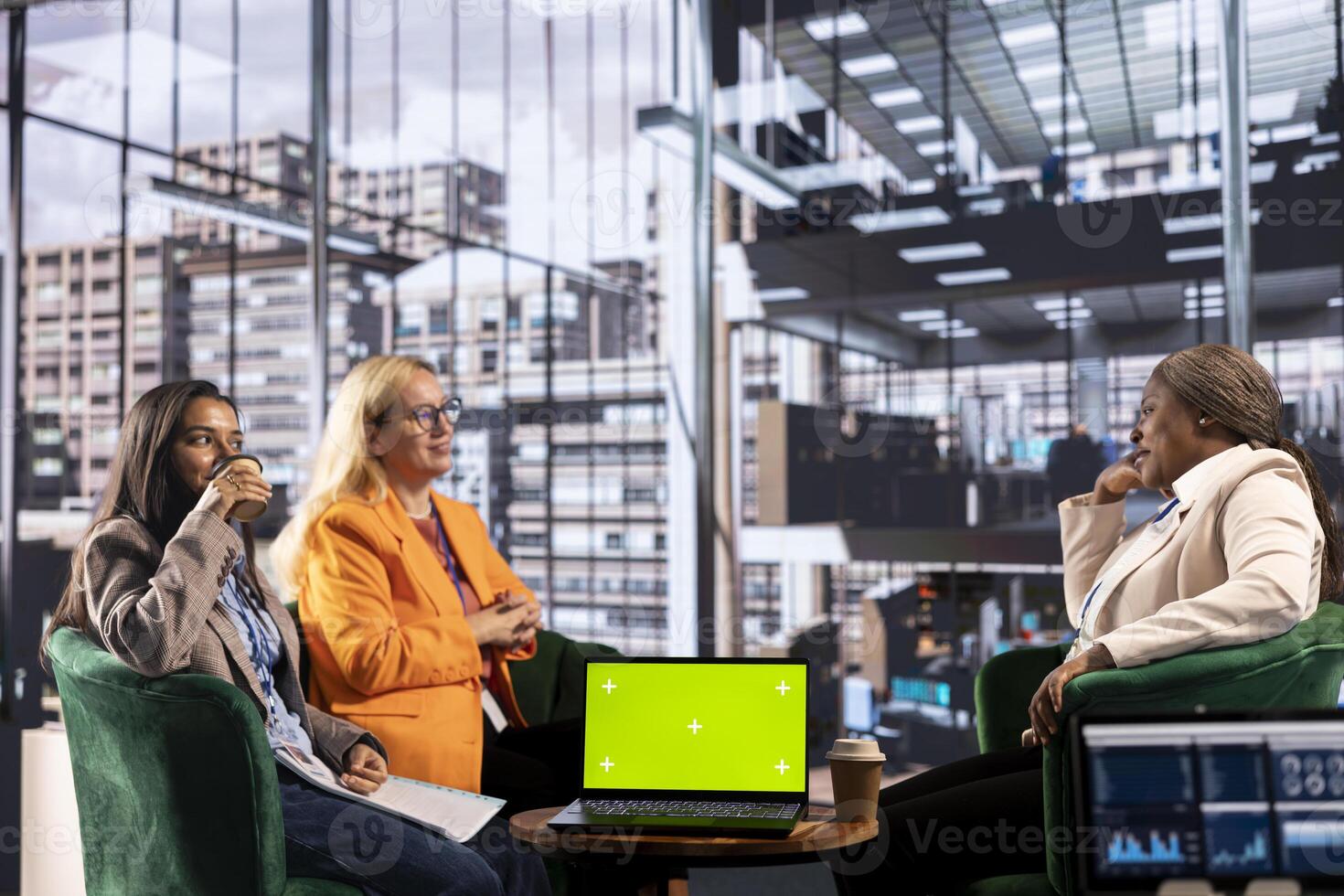 Group of multiethnic women working hard to prove themselves next to chroma key, fighting for success in a men dominated business industry. Diverse colleagues ensuring firm expansion. photo