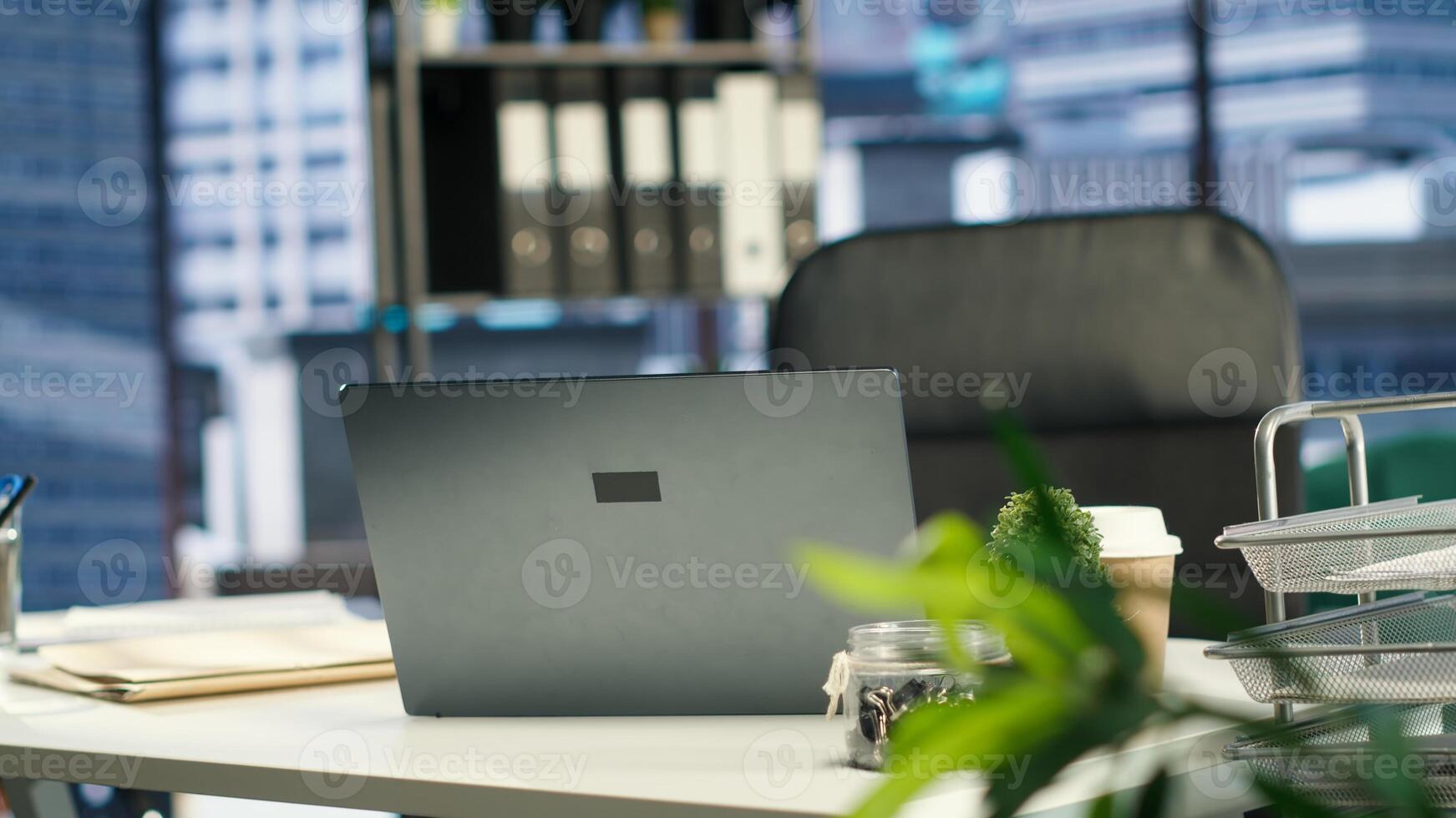 Empty modern corporate high end office space designed for a leader or person with authority, running analytics and reports on screen. Urban global enterprise workspace, empowerment. photo