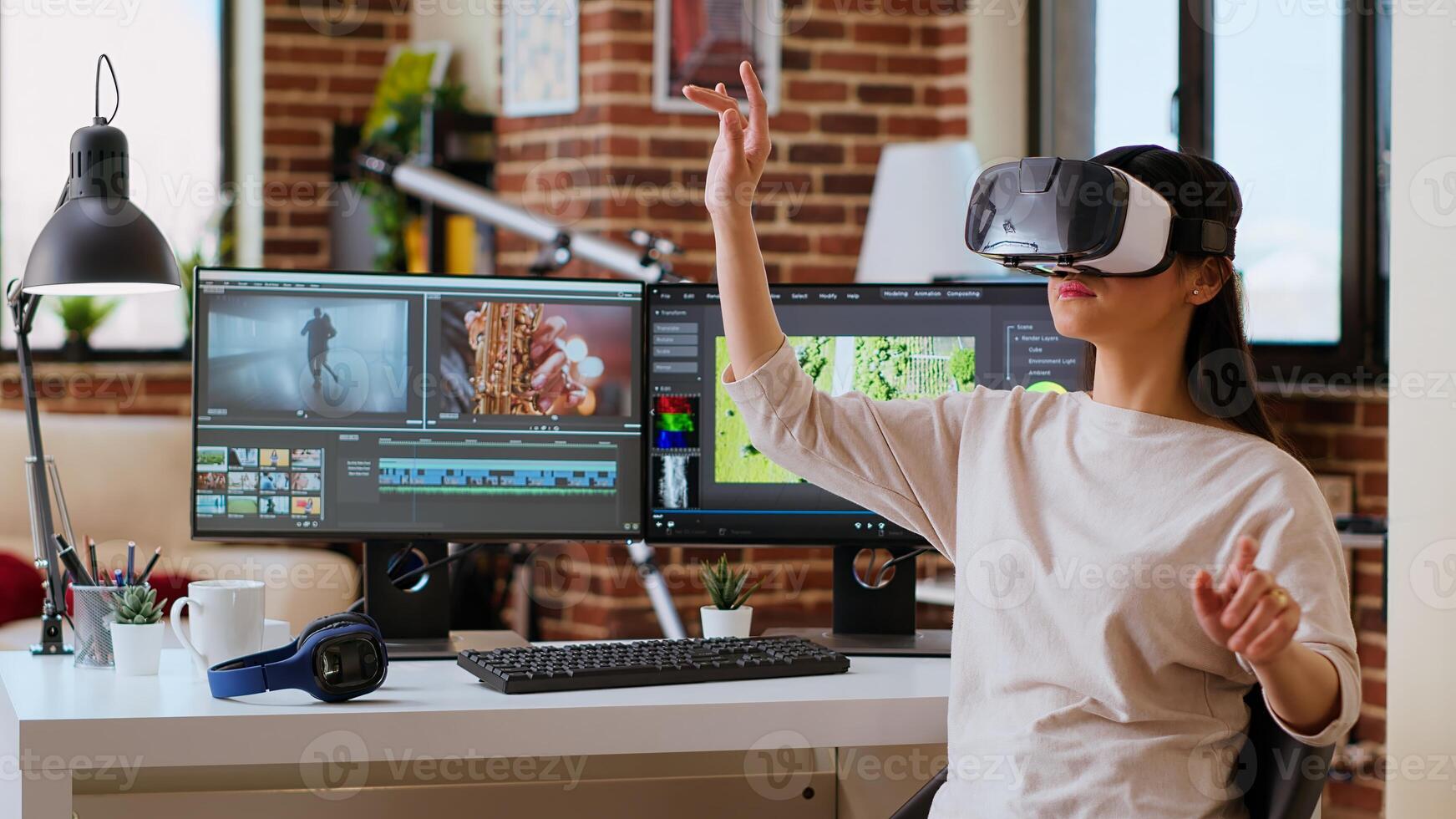 Asian woman creator uses virtual reality headset at her desk, modern tech tools for her creative occupation. Female artist editing and mixing clips for cinematic project. Camera B. photo