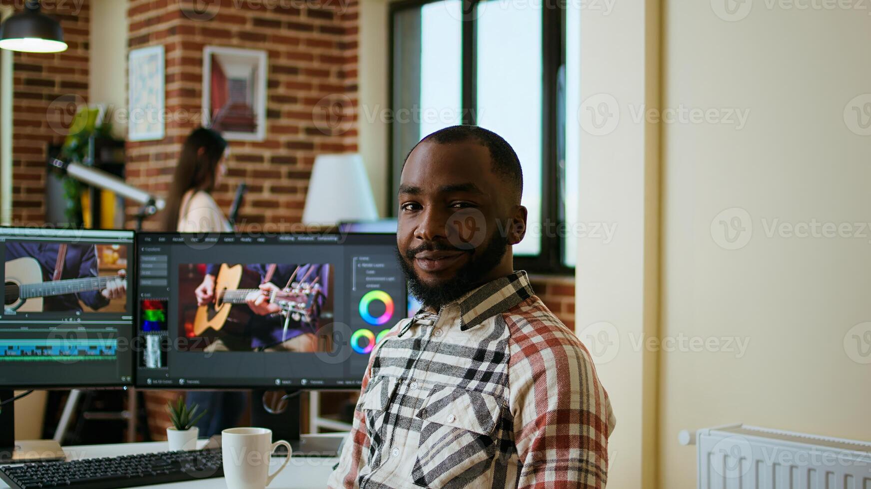 Male filmmaker editing montage on professional software, doing freelance work for a cinematic project using dual monitors. Young man working on a creative process at home. Camera A. photo