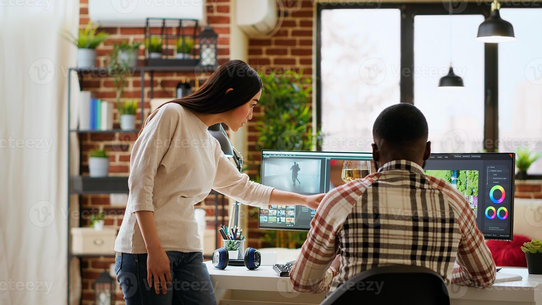 Creative interracial couple collaborating on editing process, discussing multiple ways to use the professional software and color wheel. Diverse multiethnic man and woman at home. Camera B. photo