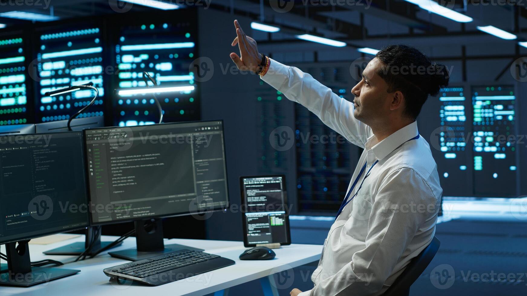 Admin in data center using augmented reality technology to ensure system can handle networking tasks. Server room worker looking at AR visualization hologram, tracking network traffic, camera A photo