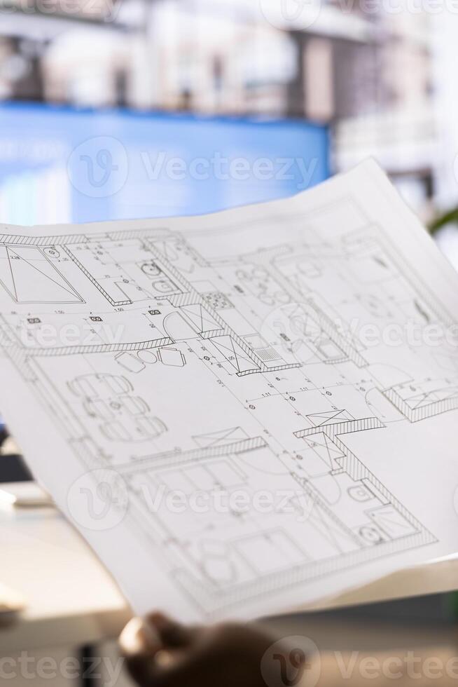 Architect drawing schematics providing technical and aesthetic advice on the design of infrastructures. Close up of architecture specialist designing plans for buildings restorations and alterations photo