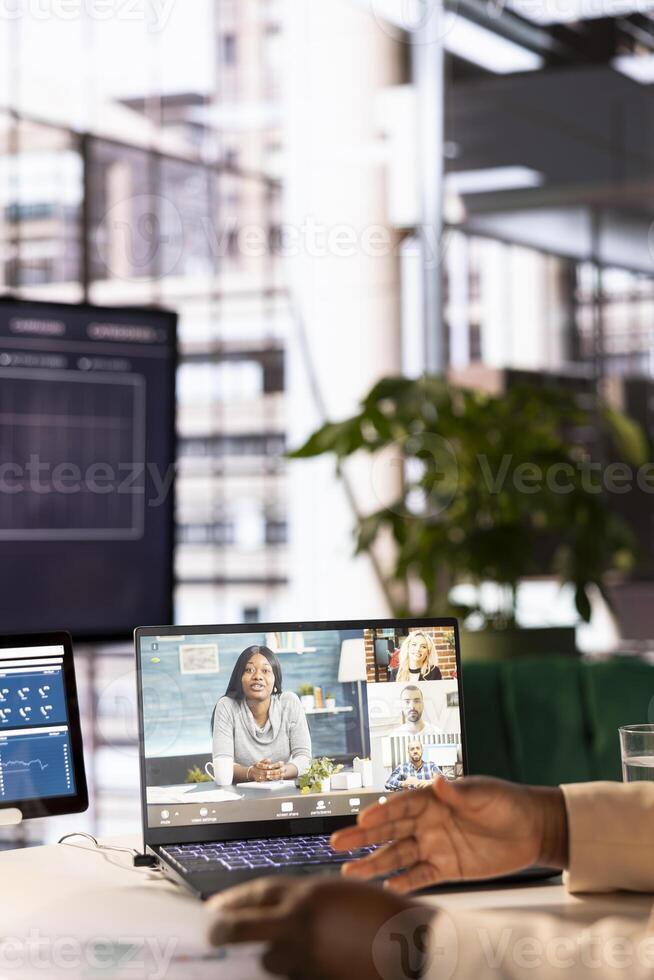 Company CEO using laptop in office to attend videoconference, talking with director board, presenting growth ideas. Close up of business president pitching strategy on videocall to partners photo
