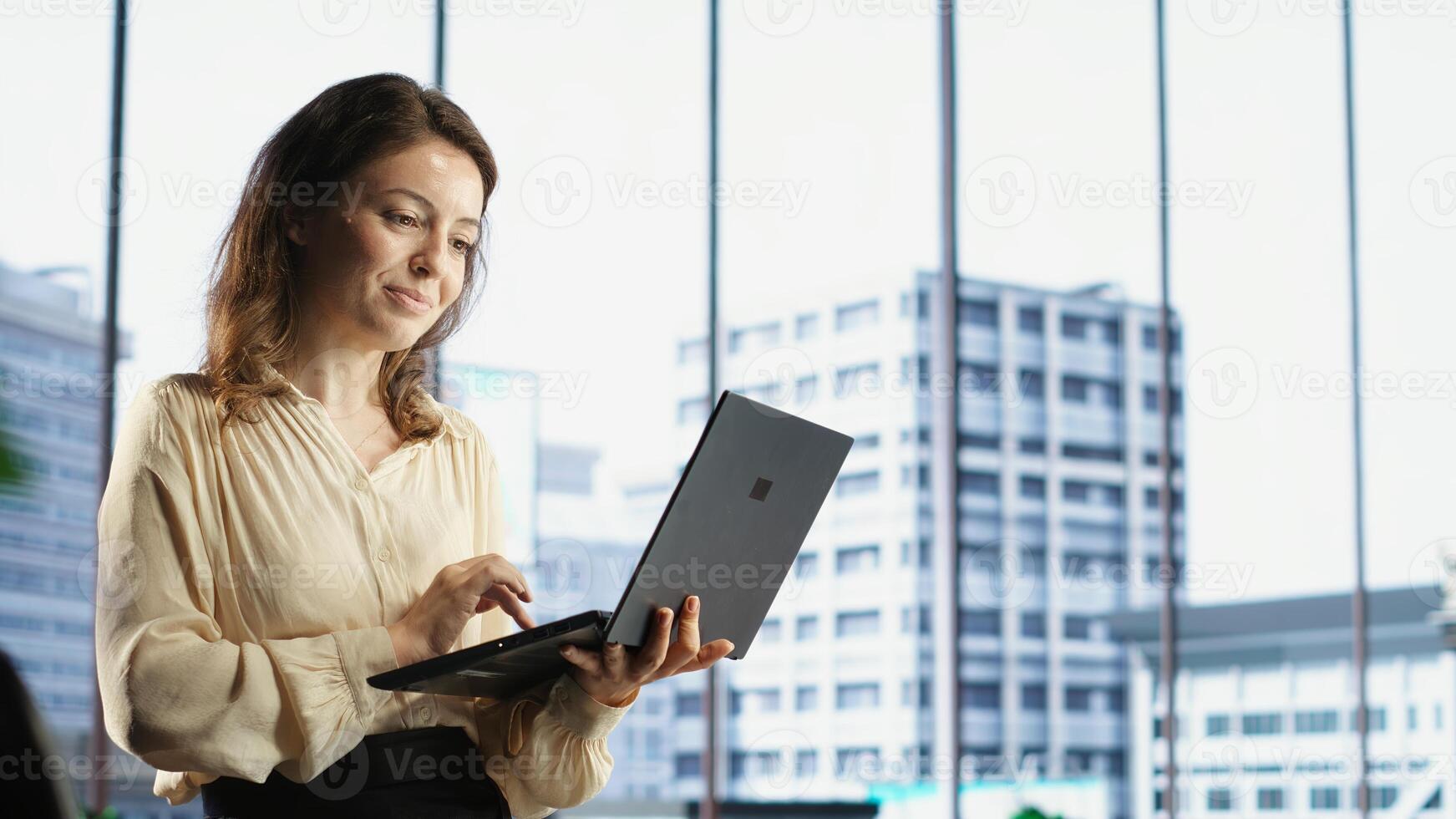 Determined female entrepreneur oversees a strategic review of the company activity, analyzing market trends and setting new priorities. Ensuring the enterprise objectives achievements. Camera B. photo