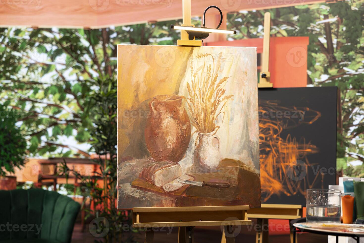 Empty artistic atelier with a rustic watercolor painting displayed on canvas, creative process with acrylic paint in a contemporary art and craft workshop. Masterpiece creation and supplies. photo