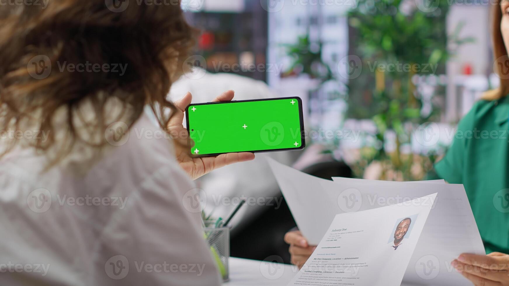 HR team selecting candidates and using a copy space mockup display in high end office, working on finding the best applicant for the job opening. Recruiters review resumes. Camera A. photo