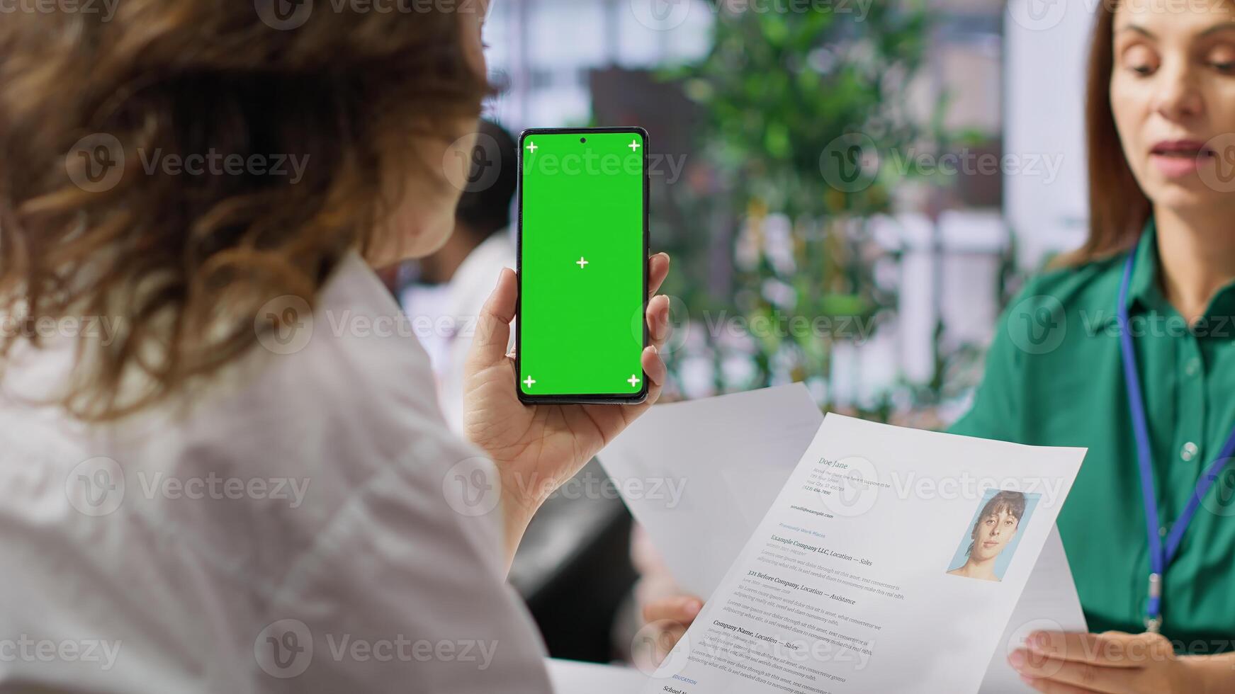 Recruiters team evaluating applicants resumes next to a green screen, looking at qualifications and work experience. HR experts selecting candidates to fill in a job vacancy at corporation. Camera A. photo