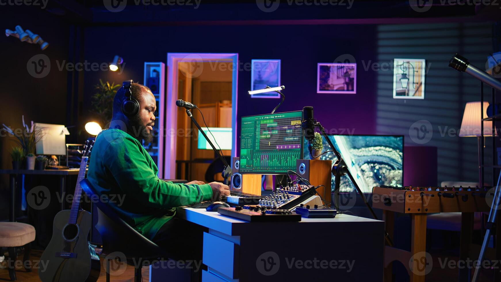 Audio engineer working in home studio with digital software on pc, playing piano keys and editing audio recordings. Musician producer creating tracks on midi controller keyboard notes. Camera B. photo