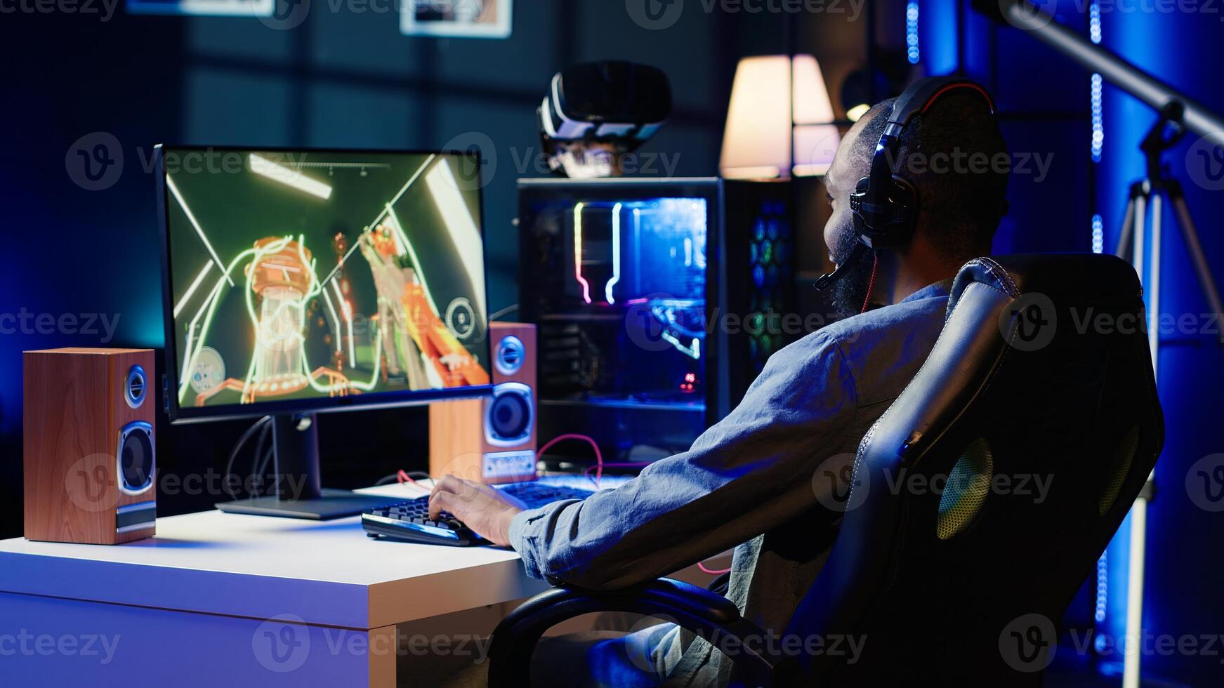 Gamer celebrating winning online multiplayer science fiction videogame tournament, pumping fists in air. Man feeling pleased about gaming championship victory on computer, camera A photo