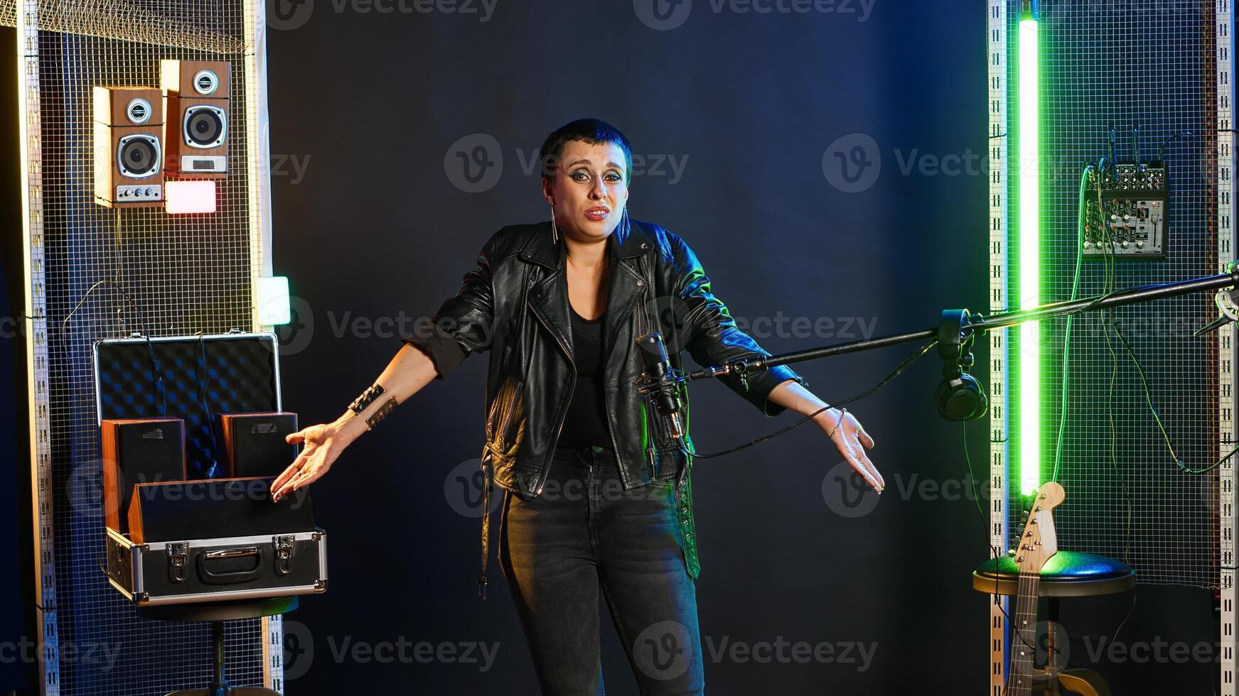 Heavy metal performer acting uncertain and shrugging in doubt, being clueless and uncertain about an answer. Confused doubtful woman artist having no idea about something. Camera B. photo