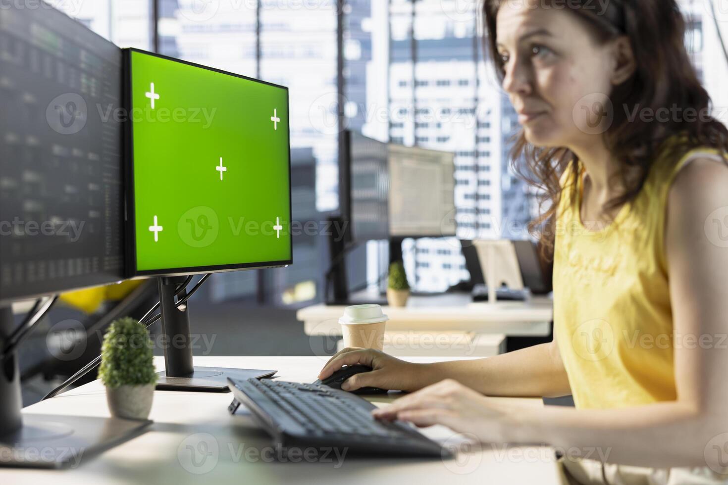 Woman testing and deploying machine learning programs and systems on isolated screen PC, solving tasks. Software engineer checking code on chroma key PC, sitting at desk in office photo