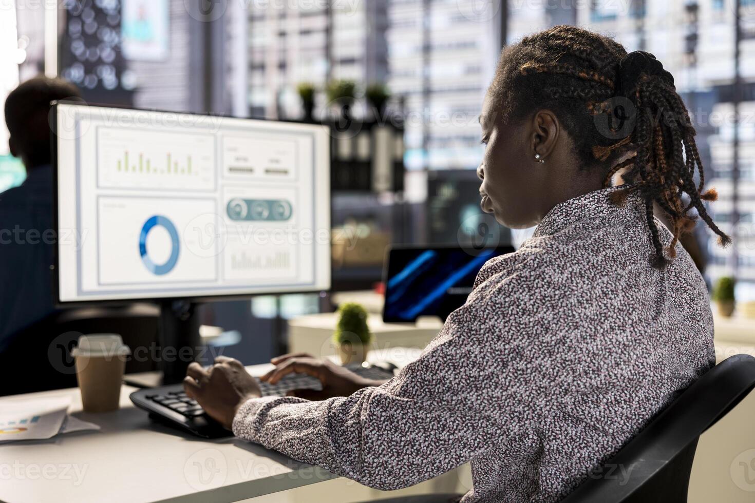 Businesswoman analyzing performance metrics on her computer at the workplace, office life. Engaged in strategic planning, she reviews data to support company objectives for successful outcomes. photo