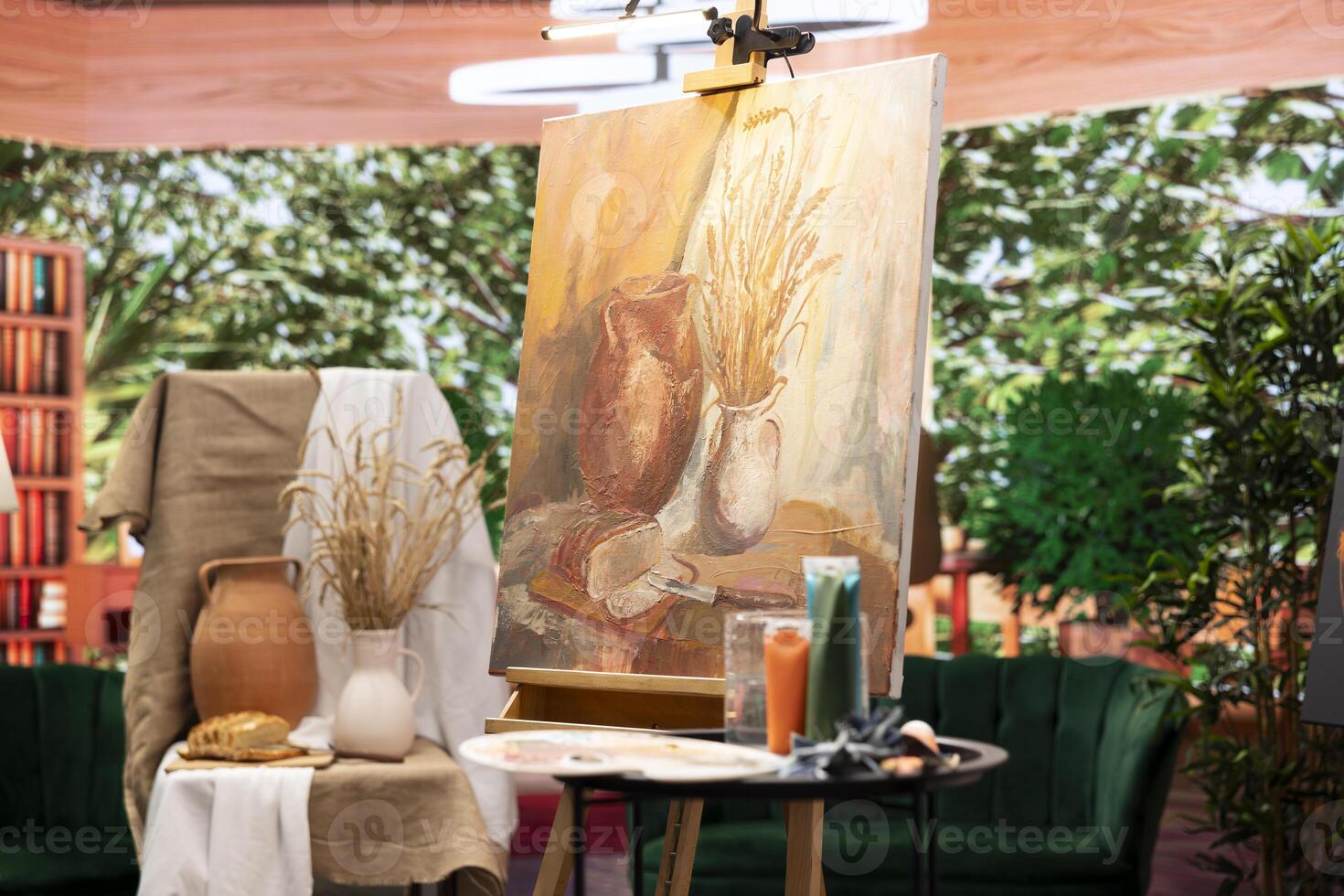 Empty art and craft workshop with a rustic beautiful painting on canvas, creative work with watercolor paint in a modern contemporary atelier. Artistic masterpiece with paint tubes and tools. photo