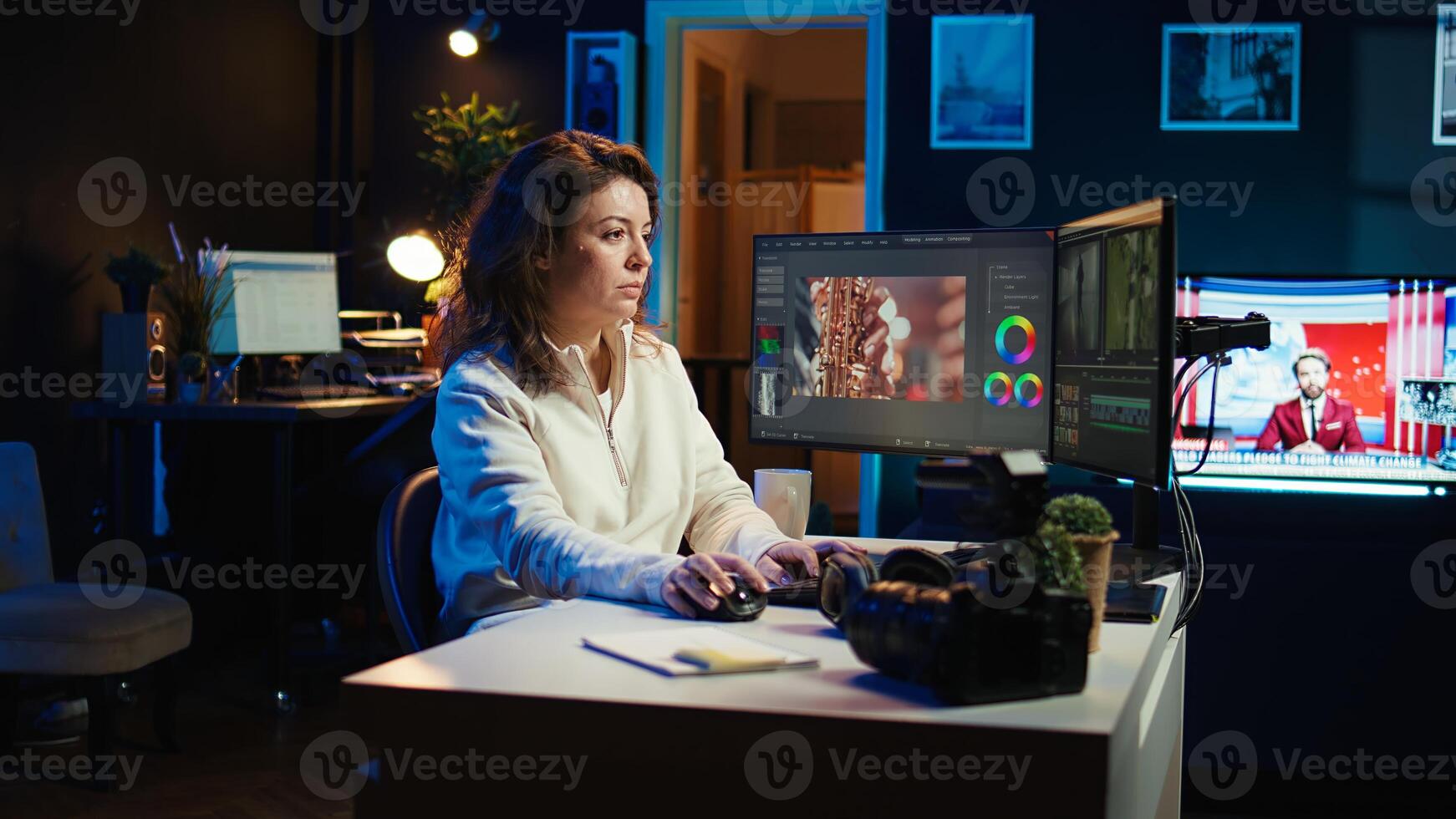 editor selecting key frames to use while doing montage, working from home on computer. Cheerful woman using mouse to edit movie project footage in office, camera B photo