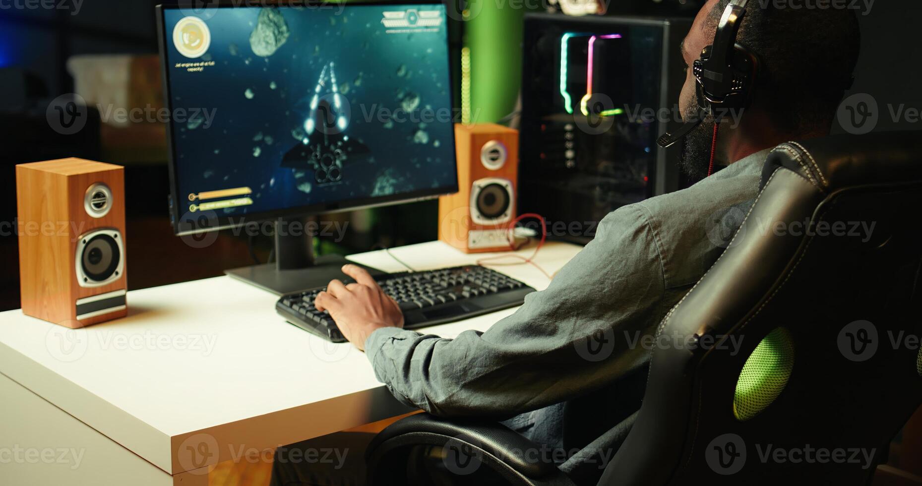 Gamer using headphones to discuss with mates while playing online SF videogame, close up. Close up enjoying futuristic coop spaceship flying arcade game with friends, chatting on internet, camera B photo
