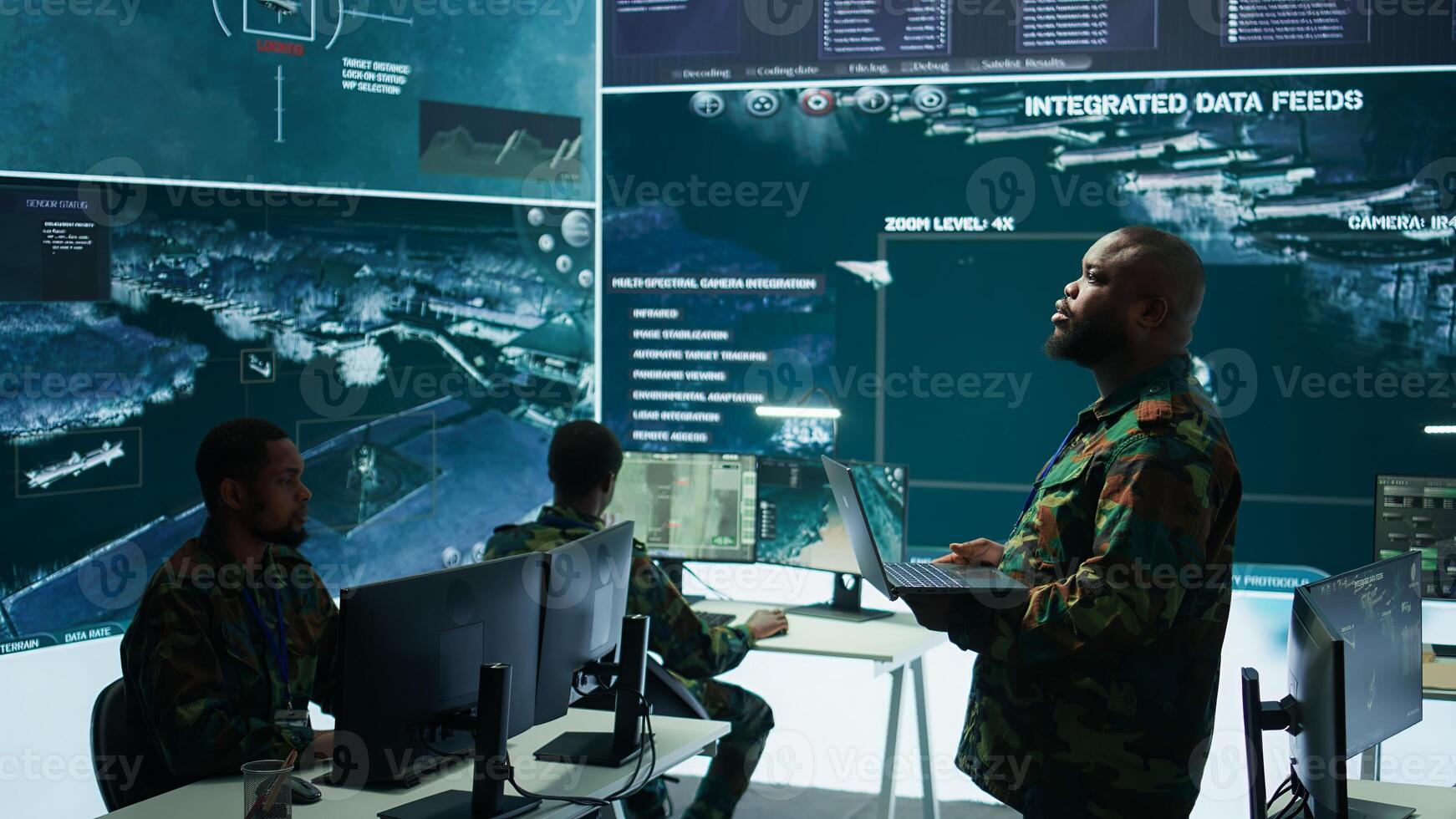 Military specialists work in a high tech command post center, focusing on cybersecurity, surveillance and data protection to ensure the security and integrity of national information. Camera B. photo
